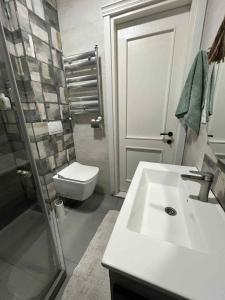 a bathroom with a sink and a toilet at BST Batumi Leo in Angisa +15 photos