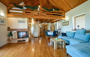 a living room with blue couches and a fireplace at Villa Panorama Hill by Villas Guide in Cestica