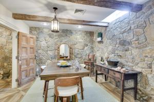 - une cuisine avec une table et un mur en pierre dans l'établissement French Château Near Beaches, Mystic and Casinos!, à Stonington