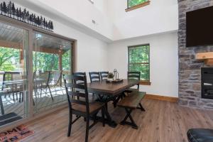a dining room with a table and chairs and a fireplace at Peaceful Timbers Getaway in Hollister