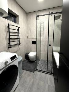 a bathroom with a toilet and a glass shower at Savanna Mountain forest resort in Yablunytsya +73 photos