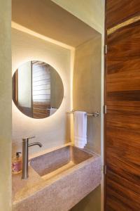 a bathroom with a sink and a mirror at Casa Palmeras 1 - Amazing Beach House in Brisas de Zicatela