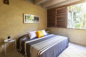a bedroom with a large bed and a window at Casa Palmeras 1 - Amazing Beach House in Brisas de Zicatela +20 photos