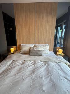 a large white bed in a bedroom with two lamps at AD Luxe Lake Suite in Ohrid +24 photos