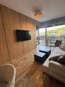 a living room with a couch and a flat screen tv at AD Luxe Lake Suite in Ohrid