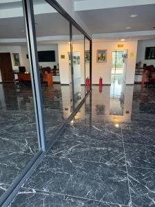 an empty lobby with marble floors and glass walls at AD Luxe Lake Suite in Ohrid