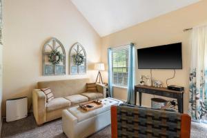 a living room with a couch and a tv at Warm Welcome Getaway - Resort Stay for 6 in Branson