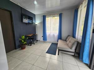 a living room with a couch and a table at Casa Vista Arenal in Fortuna