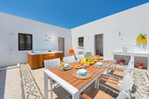 a dining room with a table and chairs at Lindos Diamond Exclusive Villa in Líndos