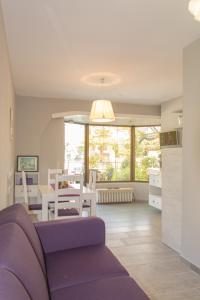 a living room with a purple couch and a table at Apartments Masek in Poreč