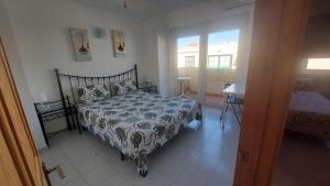 a bedroom with a bed and a table and a window at Castillo Mar in Caleta De Fuste +60 photos