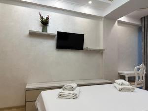 a room with two beds and a flat screen tv at Central Luxury Apartments in Chişinău
