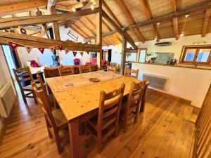 a dining room with a wooden table and chairs at Chalet Chardons - Chalet Authentique proche des 3 Vallées MAE-3704 in Saint-Martin-de-Belleville