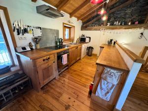 a kitchen with wooden cabinets and a counter top at Chalet Chardons - Chalet Authentique proche des 3 Vallées MAE-3704 in Saint-Martin-de-Belleville +10 photos