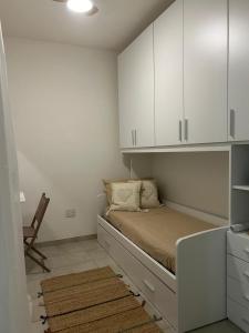 a bedroom with a bed with white cabinets and a rug at Casa Lore in San Pietro in Bevagna