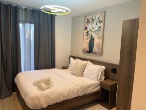a bedroom with a bed with a towel on it at Loxwood by Tripview Apartments in Accra +61 photos