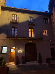 a large building with two balconies on top of it at El Portalet de Can Rialla in Santa Pau