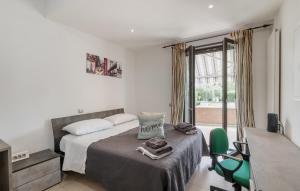 a bedroom with a bed and a green chair at Lovely Home In Velletri With Wifi in Velletri +55 photos