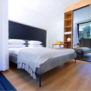 a bedroom with a large bed and a large window at Mkhuhla Multi Residence in Roodepoort