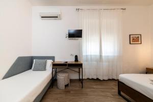 A bed or beds in a room at NG Guest House l'Acquedotto