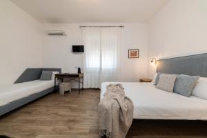 A bed or beds in a room at NG Guest House l'Acquedotto