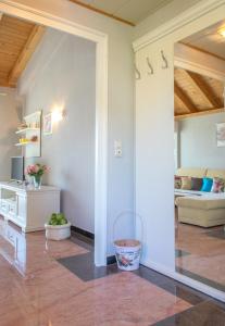 a living room with a room with a couch and a table at Apartments Masek in Poreč