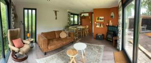 a living room with a couch and a table at Relax Chalet Veluwe in Putten