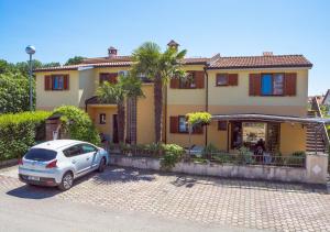 a car parked in front of a house at Apartments Masek in Poreč