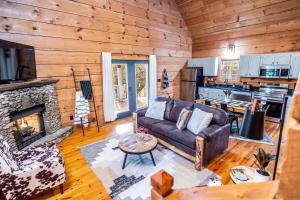 a living room with a couch and a fireplace at Private Getaway, Arcade Game, Hot Tub & Fire Pit in Townsend