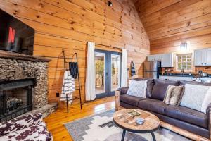 a living room with a couch and a fireplace at Private Getaway, Arcade Game, Hot Tub & Fire Pit in Townsend