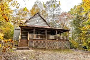 a cabin in the woods with a porch at Private Getaway, Arcade Game, Hot Tub & Fire Pit in Townsend
