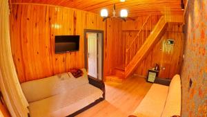 a living room with a couch and a flat screen tv at Meric Hotel in Uzungöl
