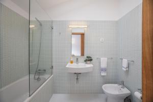 a bathroom with a sink and a toilet and a shower at Modern 2-bedroom apartment in the Historic Center in Braga +10 photos