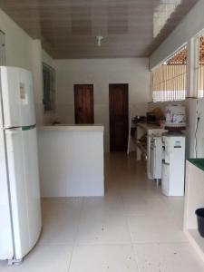 a large kitchen with white appliances in a room at Casa São Francisco in Belém