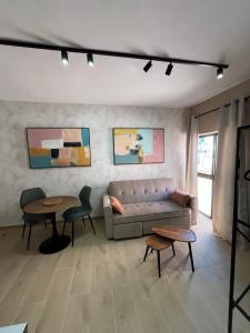 a living room with a couch and two tables at CORNELIAS HOME Estudio 5B in Los Cristianos