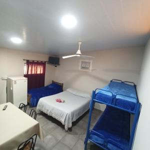 a room with two bunk beds and a refrigerator at Complejo Corrientes Depto 4 in Jesús María