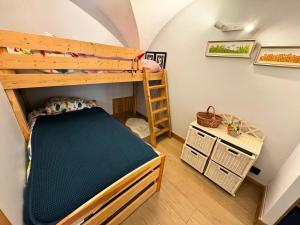 a bedroom with a bunk bed and a ladder at Chalet Aster - Maison de village rénovée sur 3 niveaux 4 pièces pour 6 personnes à St Marcel MAE-6444 in Saint-Marcel
