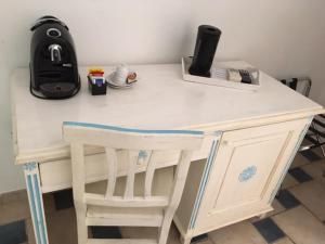 a white desk with a chair in a room at Hotel Patti in Golfo Aranci