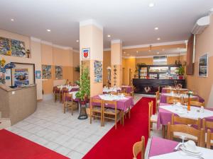 a restaurant with tables and chairs with purple tables at Villa Valentina in Zadar