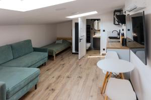 a living room with a couch and a table at Apartament Green in Rzeszów