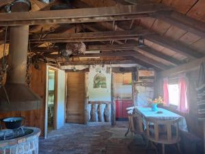 a dining room with a table and a stove at The LODGE in Risan
