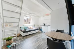 a living room with a couch and a table at Studio 5, à 5min de la gare avec WIFI in Lens +3 photos