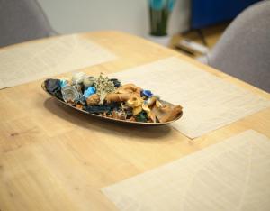 a plate of food sitting on a wooden table at Gledors Luxury Apartments in Vlorë