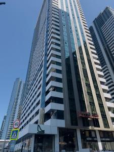 a tall building in a city with tall buildings at BST Batumi Leo in Angisa