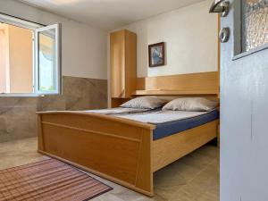 a large bed in a room with a window at Lantana ex Villa Americana in Karlobag