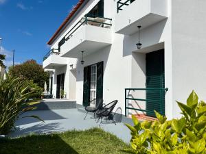 two chairs sitting on the patio of a house at Beach Relax Apartment in Porto Santo