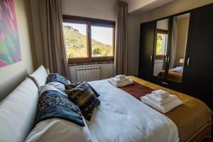 a bedroom with a large bed with towels on it at Villa Sofia in Taormina