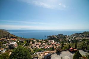 a view of a town with the ocean in the background at Villa Sofia in Taormina