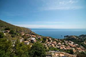 a town on a hill with the ocean in the background at Villa Sofia in Taormina