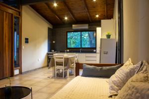 a living room with a couch and a kitchen with a table at Casa del Cerro in Yerba Buena